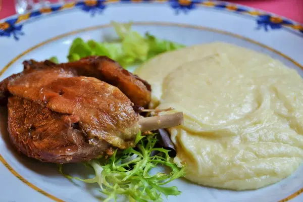 Duck confit in Paris! And that side dish is aligot, mashed potatoes and melted cheese.